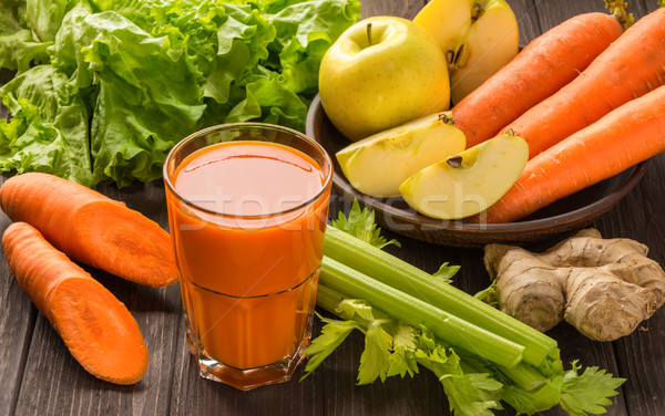 Carrot and apple juice with vegetables on dark wooden background Stock photo © markova64el