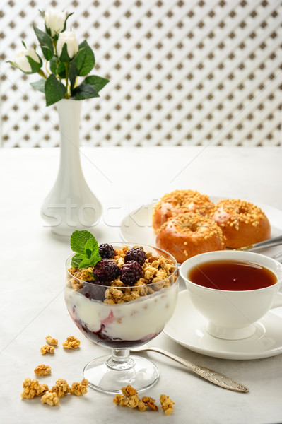 Breakfast of granola, buns brioche, honey and black tea . Stock photo © markova64el