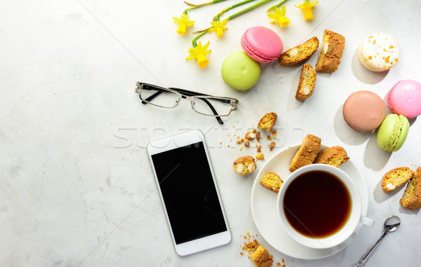 Tea with cookies, macaroons and smartphone with glasses  Stock photo © markova64el