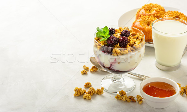 Stock photo: Breakfast of granola, buns brioche, honey and milk .