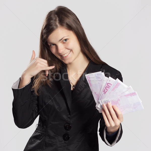 Young long-haired woman holding money Stock photo © maros_b