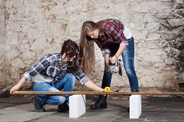 Two long-haired young woman with an angle grinder Stock photo © maros_b