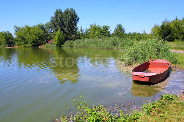 Stock photo: fishpond with red boat