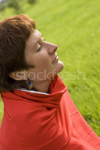 Stock photo: woman sitting on the grass