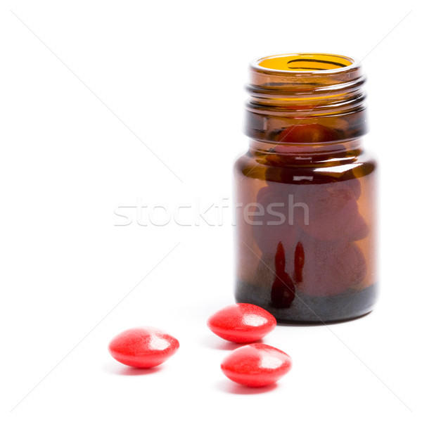 Stock photo: bottle with red pills