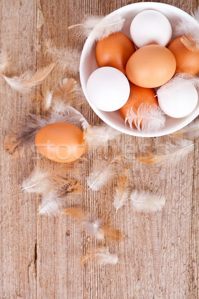 Stock photo: eggs in a bowl  and feathers