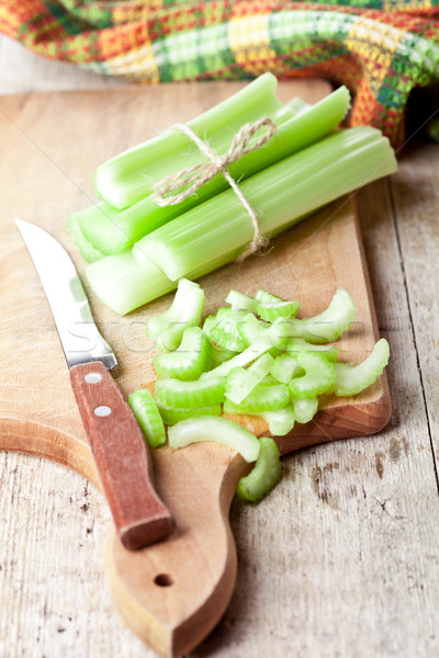 bundle of fresh green celery stems and knife Stock photo © marylooo