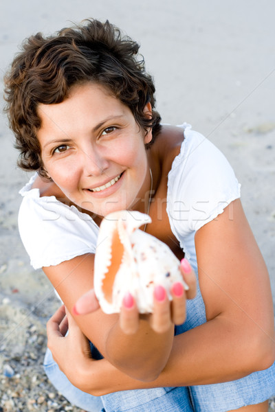  woman on seacoast with a cockleshell in hands  Stock photo © marylooo