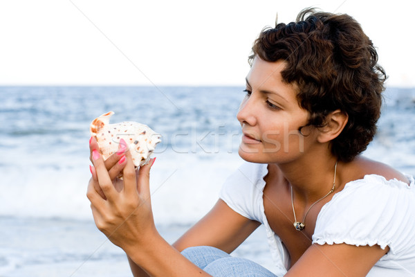 woman on seacoast with a cockleshell Stock photo © marylooo