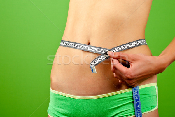 young woman measuring her slim body  Stock photo © marylooo