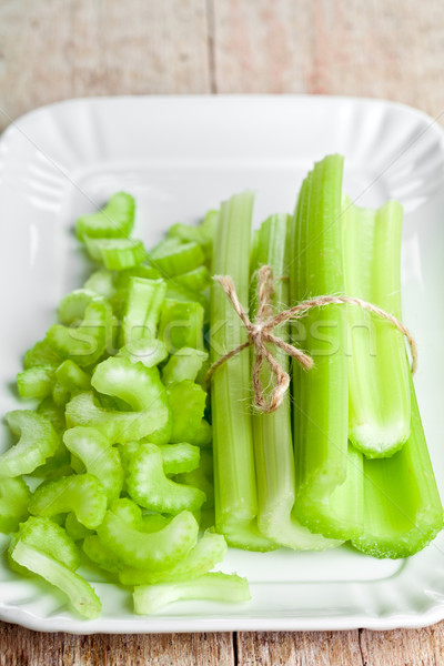 Stock photo: bundle of fresh green celery stems in plate 