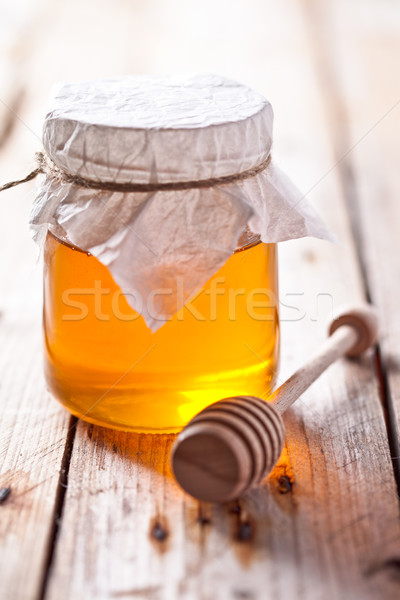 full honey pot and honey stick Stock photo © marylooo