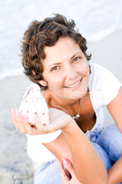 woman on seacoast with a cockleshell Stock photo © marylooo