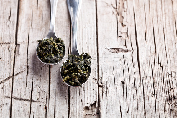 two spoons of dried green tea leaves  Stock photo © marylooo