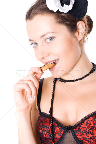 Mujer corsé pequeño sombrero comer cookie Foto stock © marylooo