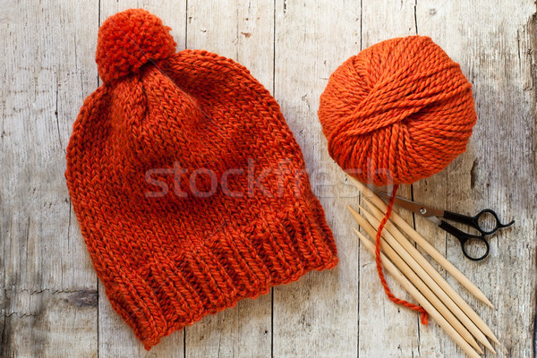 wool orange hat, knitting needles and yarn Stock photo © marylooo