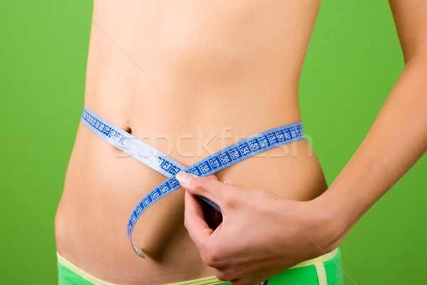 young woman measuring her slim body  Stock photo © marylooo