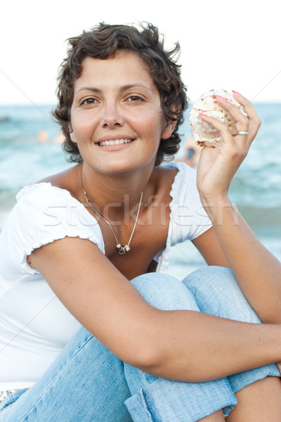 woman on seacoast with a cockleshell Stock photo © marylooo