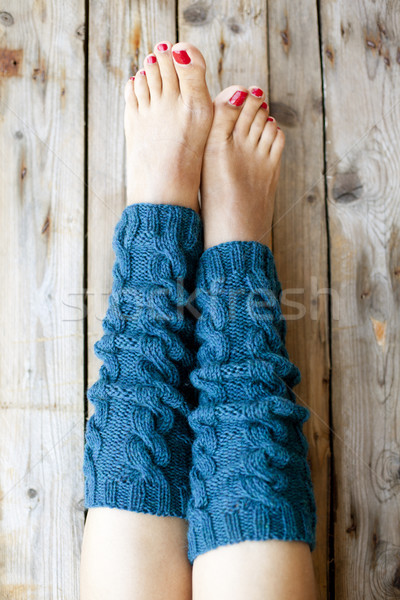 Stock photo: Woman's legs in knitted legwarmers.