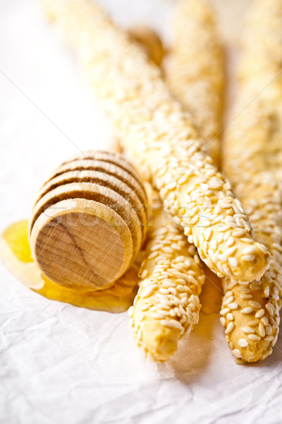 grissini with sesame seeds and honey dipper Stock photo © marylooo