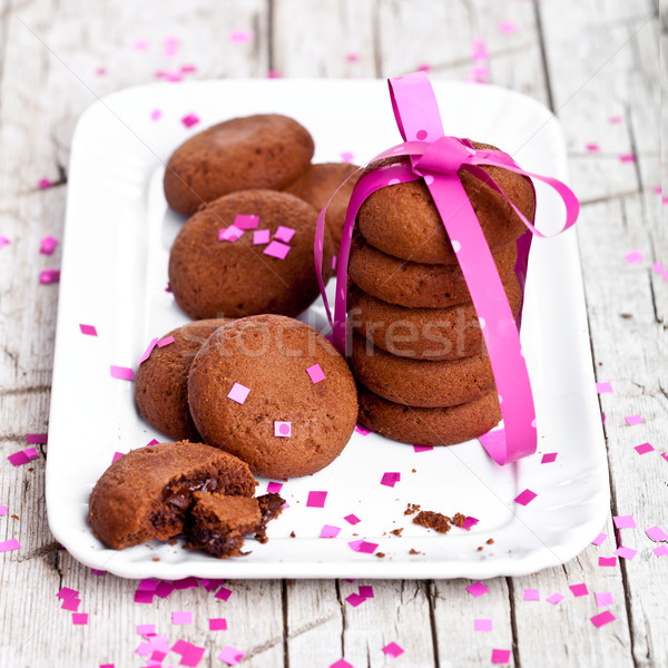 plate of fresh chocolate cookies with pink ribbon and confetti  Stock photo © marylooo