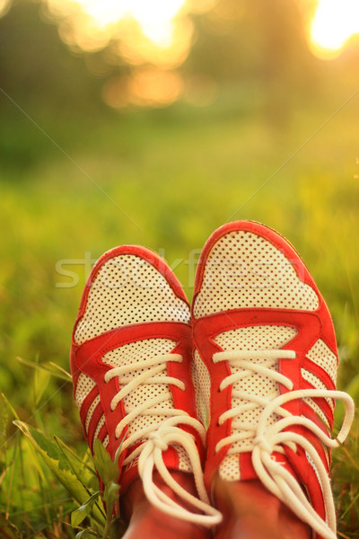 Relaxation. youth sneakers girl legs on grass, sunny day, instagram look. Stock photo © MarySan
