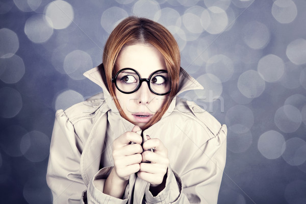 Rejtőzködik lány szemüveg köpeny stúdiófelvétel jókedv Stock fotó © Massonforstock