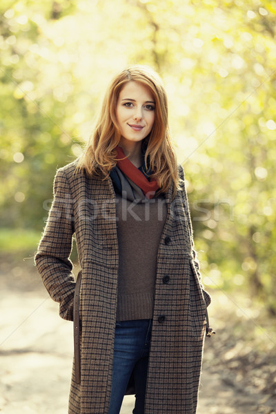 Style redhead girl at beautiful autumn alley. Stock photo © Massonforstock
