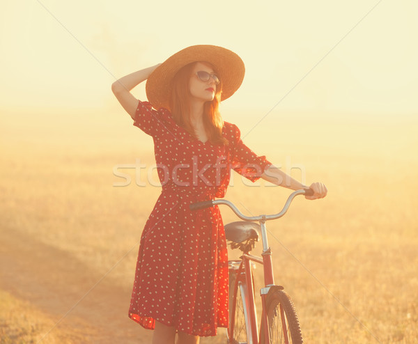 Girl on a bike in the countryside in sunrise time. Stock photo © Massonforstock