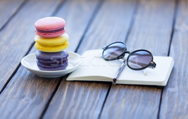 Stock photo: Macarons and little notebook with glasses 