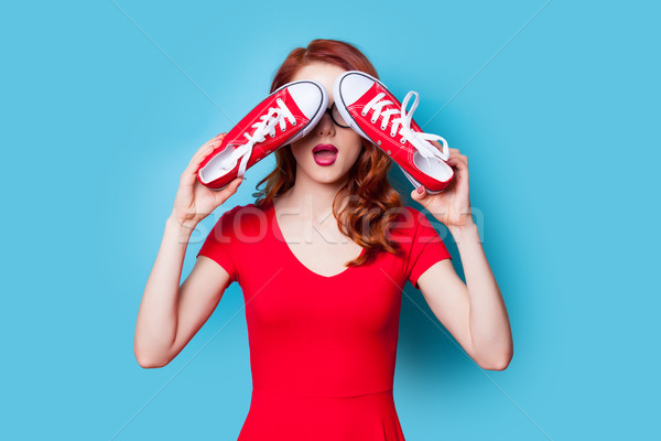 beautiful surprised young woman with gumshoes standing in front  Stock photo © Massonforstock