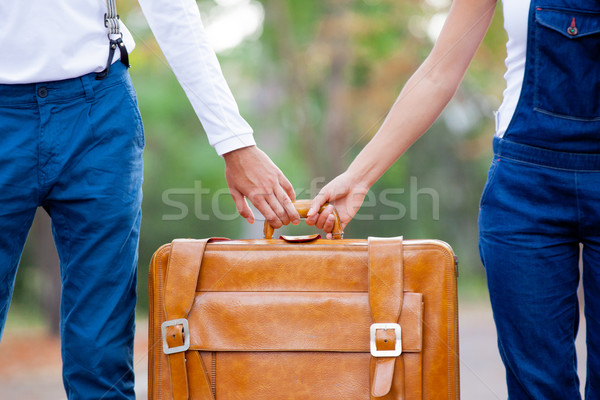 photo of cute couple holding brown suitcase on the wonderful aut Stock photo © Massonforstock