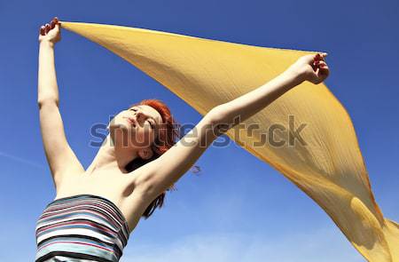 Genç kadın açmak silah sarı ipek rüzgâr Stok fotoğraf © Massonforstock