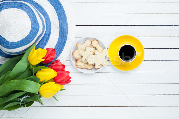 Cup of coffee with hat and tulips  Stock photo © Massonforstock