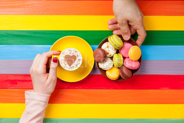 Stock photo: photo of male and female hands holding cup of coffee and plate o