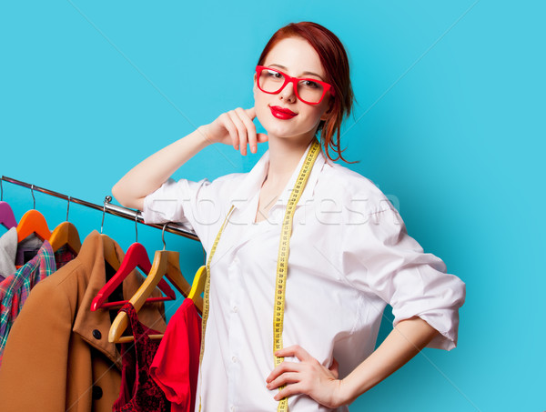 photo of beautiful young woman with centimeter near clothes on t Stock photo © Massonforstock