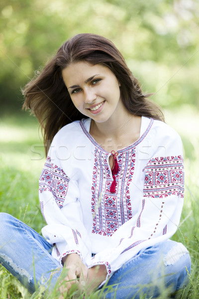 Slav teen girl at green meadow in national ukrainian clothing. Stock photo © Massonforstock