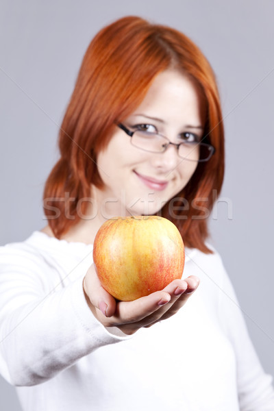 Stock photo: Girl with apple in hand. Studio shot.