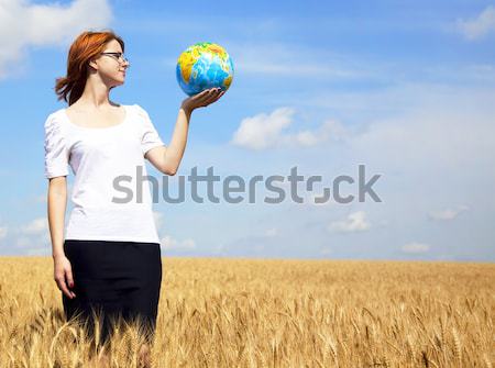 Young Businesswomen in white keeping globe in hand Stock photo © Massonforstock