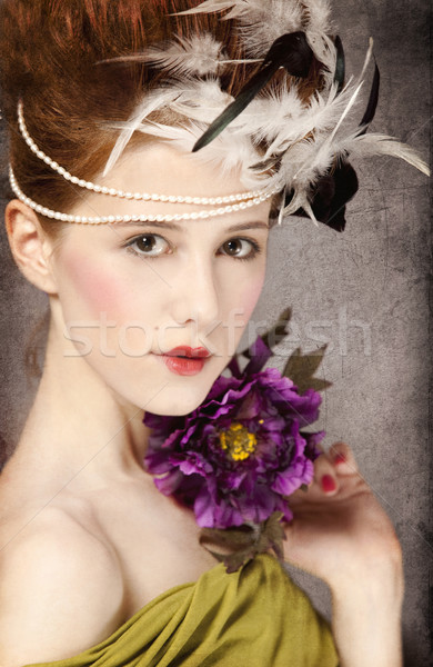 Stock photo: Redhead girl with Rococo hair style and flower at vintage backgr