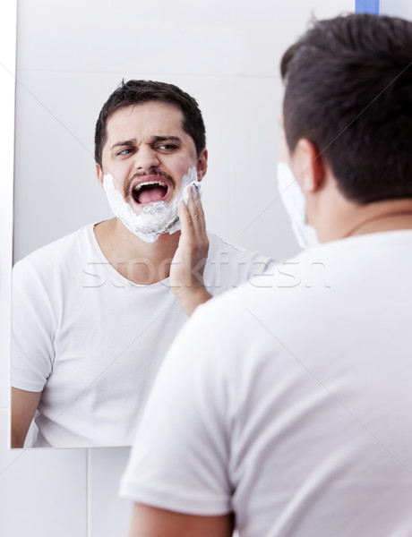Stock photo: Surprised real men shaving.