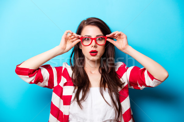 beautiful surprised young woman in glasses standing in front of  Stock photo © Massonforstock