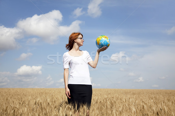 Young Businesswomen in white keeping globe in hand at wheat fiel Stock photo © Massonforstock