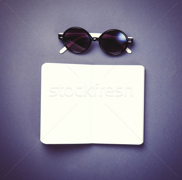 Sunglasses and classic notebook on violet background. Stock photo © Massonforstock