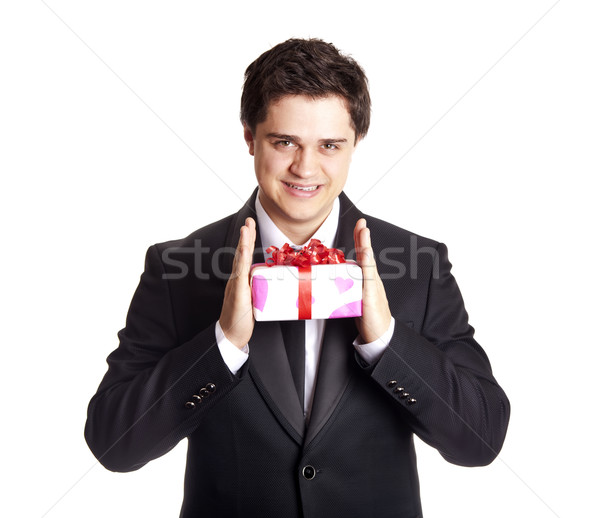 A man holding present box in formal black tux Stock photo © Massonforstock