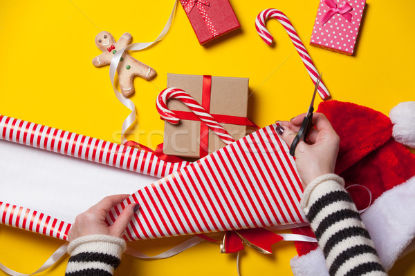 Stock photo: Female hands wrapping a gift