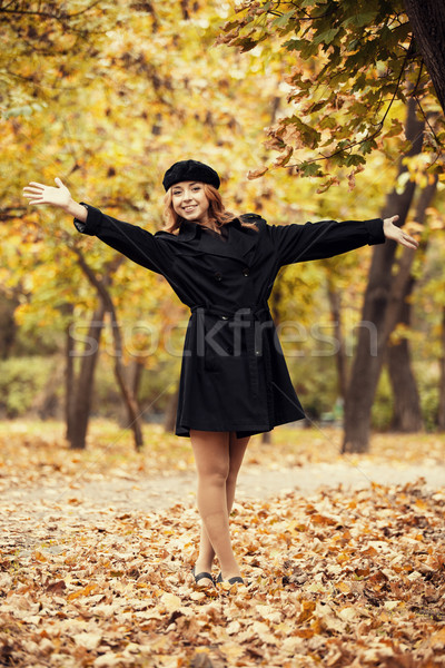 Redhead girl in the autumn park. Stock photo © Massonforstock