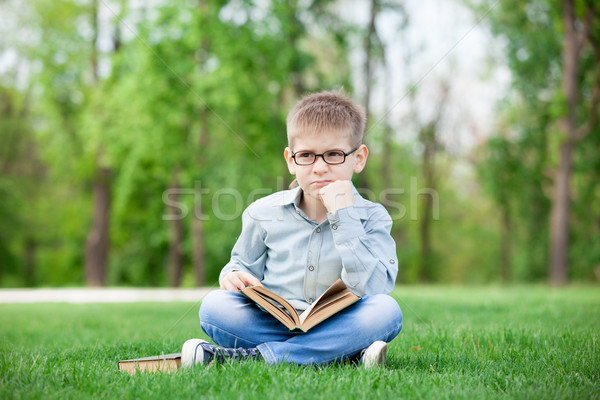 Triste nino libro hierba verde retrato jóvenes Foto stock © Massonforstock