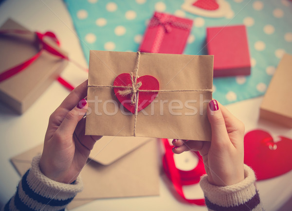 female hands holding envelope with a heart Stock photo © Massonforstock