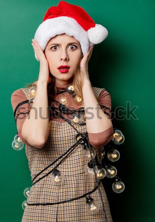 photo of beautiful young woman with retro phone in santa claus h Stock photo © Massonforstock